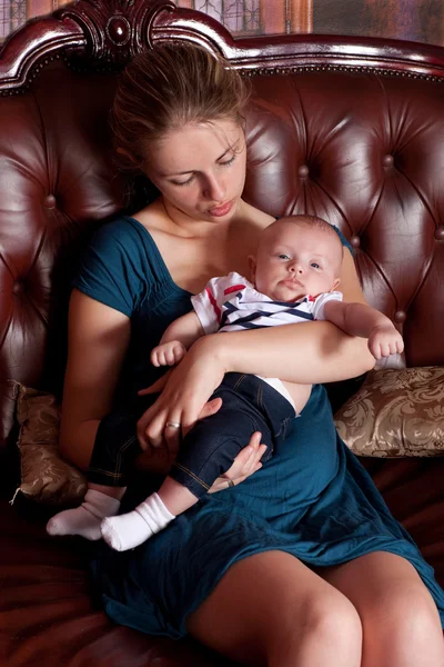 ソファの上の彼女の赤ん坊と母親 — ストック写真