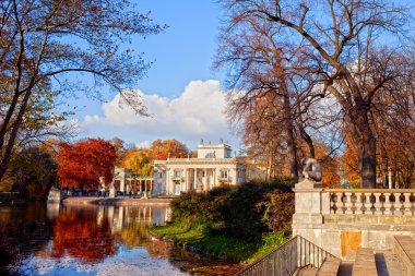 Lazienki Park in autumn with Palace on the Water in Warsaw, Poland clipart