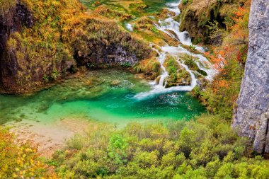 Crystal clear mountain stream in autumn scenery of Plitvice Lakes in Croatia clipart