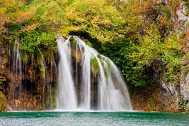 Scenic waterfall in a picturesque autumn scenery of the Plitvice Lakes National Park in Croatia clipart