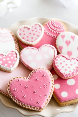 Heart shaped cookies with pink and white icing clipart