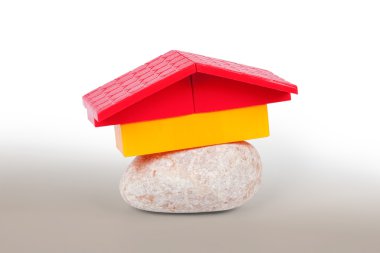 Conceptual model of the house, made of stone and the roof of toy clipart