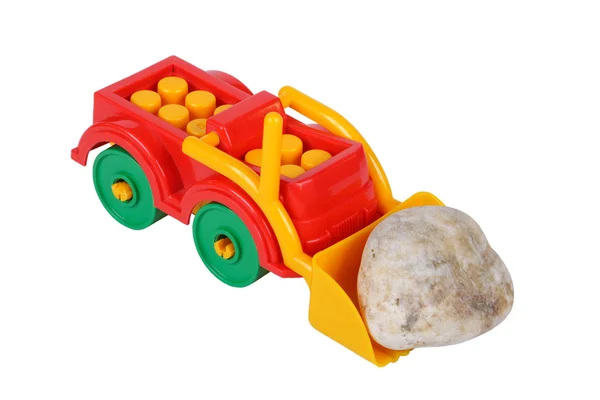Traktorspielzeug und Stein — Stockfoto