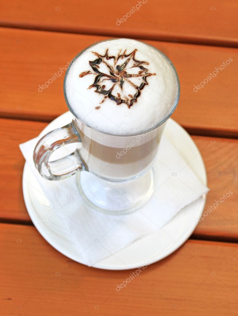 Latte macchiato with cocoa powder in the form of flower