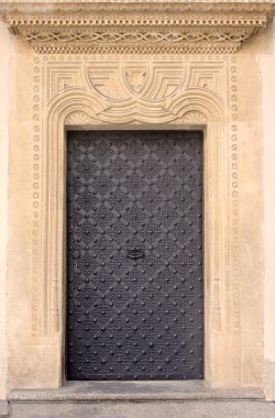 Old door with ornament in stone wall. Royal Wawel Castle, Cracow. Poland clipart