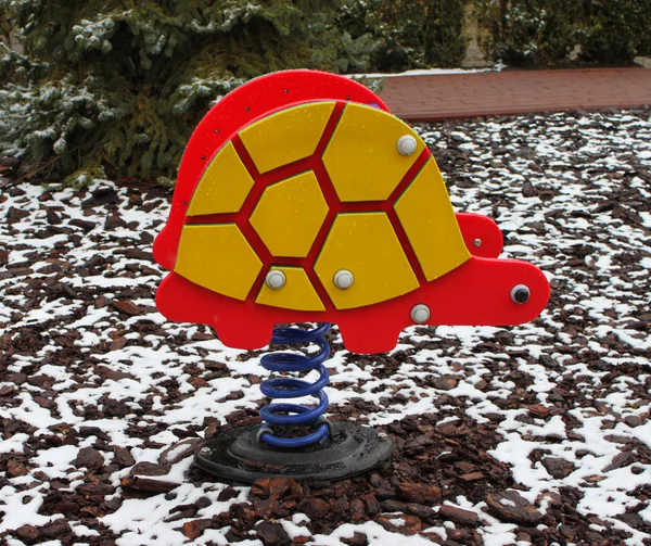 Empty turtle toy on playground in winter — Stock Photo, Image