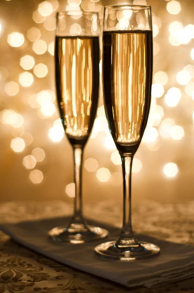 Šampaňské ve skle na pozadí bokeh — Stock fotografie