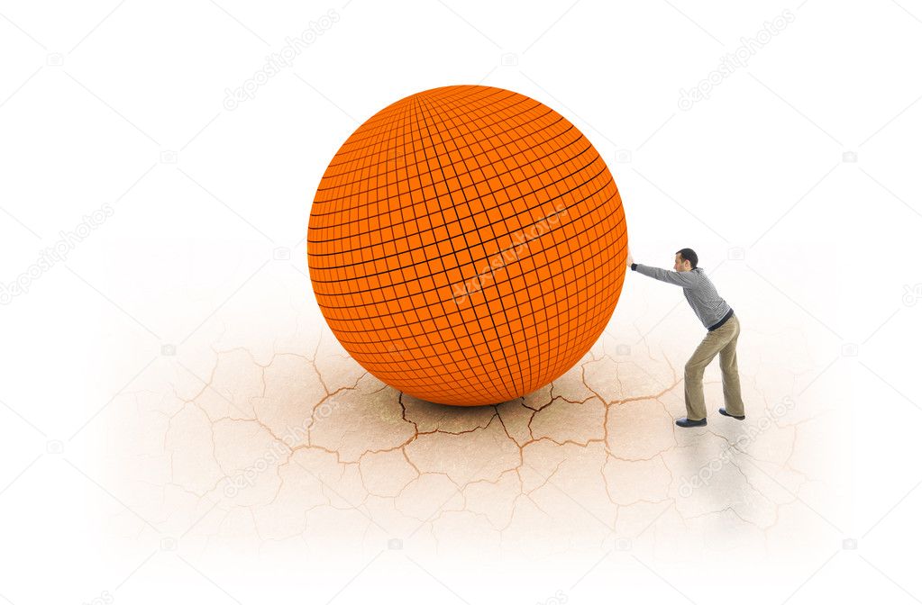 Young man pushing big and heavy ball on cracked earth