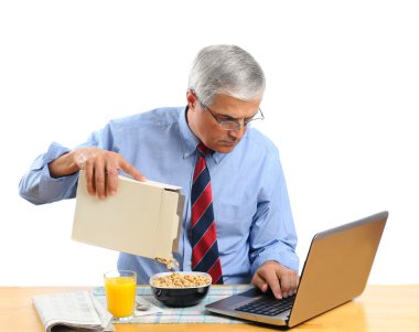 Middle Aged Man Pouring Cereal into a Bowl clipart