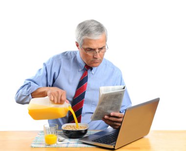 Middle Aged Man Pouring Milk into His Cereal Bowl clipart