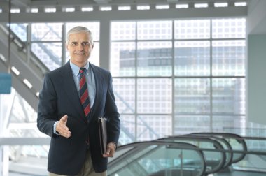 Businessman in Lobby of Modern Building clipart