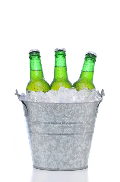 Green beer bottles in a bucket of ice — Stock Photo, Image