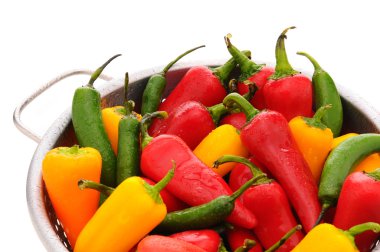 Assorted peppers in colander clipart