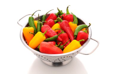 Assorted peppers in colander clipart