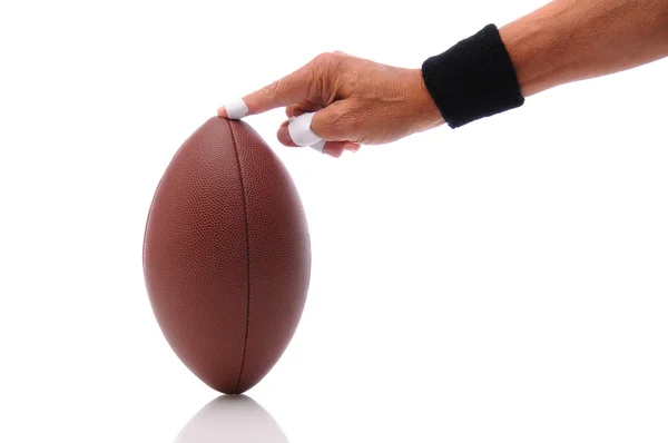Hand holding a football ready for kicking — Stock Photo, Image