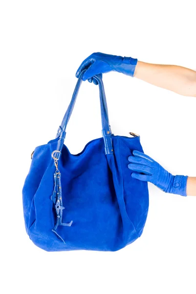 Blauwe vrouwen tas bij de hand — Stockfoto