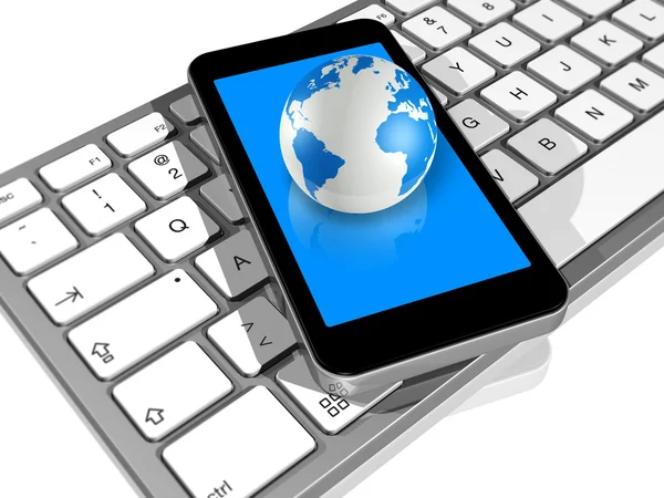World globe on a mobile phone on a computer keyboard — Stock Photo, Image