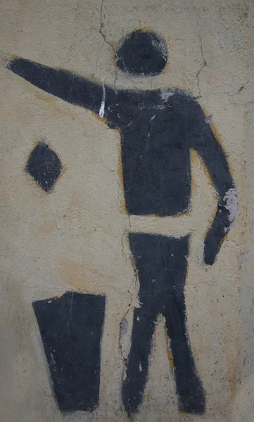 Obraz człowieka na ścianie wydalenia śmieci w kosz — Zdjęcie stockowe