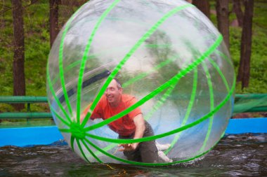 Man playing in Zorb clipart