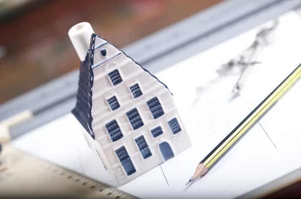 stock image Breadboard model of a house and paper with a pencil