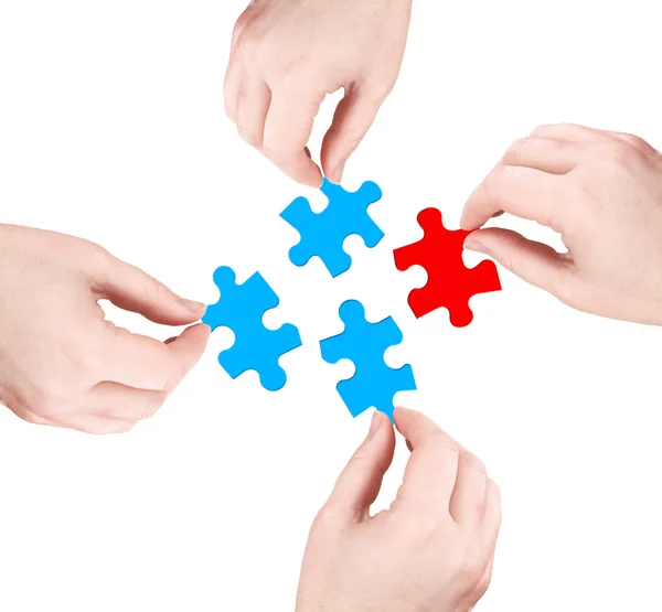Hands and red puzzle — Stockfoto