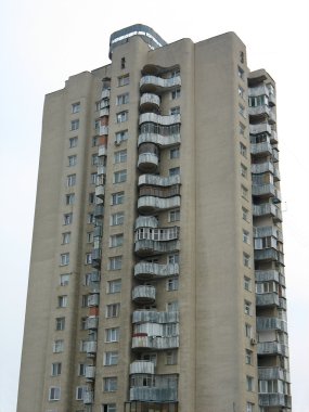 Old high multi-apartments building over sky clipart