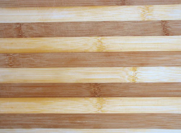 Scratched and worn wooden kitchen cutting board — Stock Photo, Image