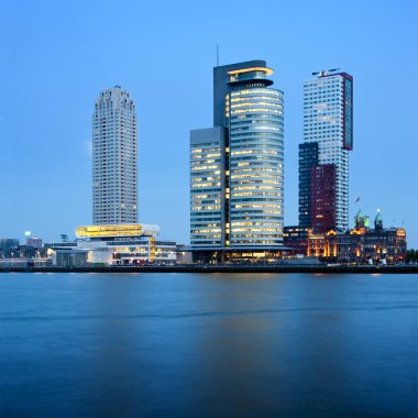 Three skyscrapers in the Rottedam Skyline, along the Muese river banks clipart