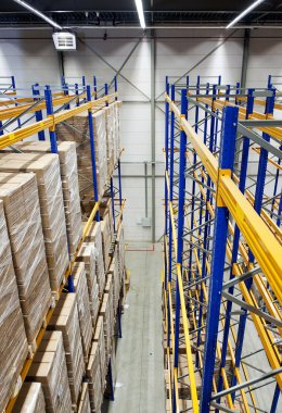 The racks and shelves of a huge warehouse seen from above clipart