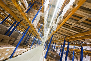 Shelves, full of boxes in a huge warehouse, ready for transport to the customer clipart