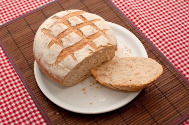 Buckwheat bread loaf on a kitchen table clipart