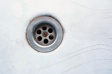 Drain that has been drained in an old obsolete bath tub clipart