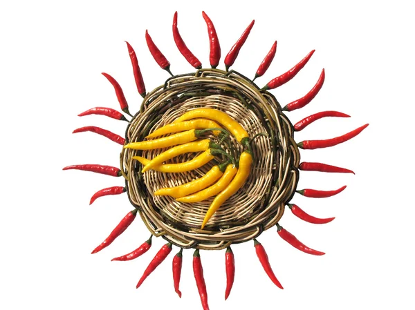 Stock image Red and yellow chili peppers on a wicker stand