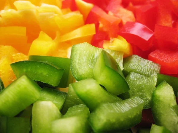 Yellow, red and green peppers Bulgarian. Slicing. Cubes Stock Fotografie
