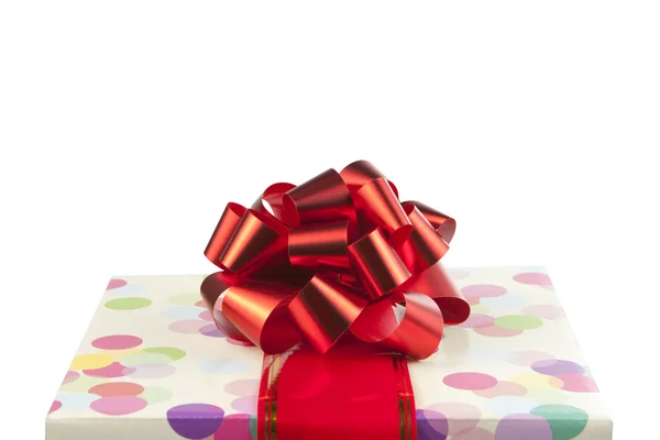 Gift with big red bow and ribbon — Stock Photo, Image