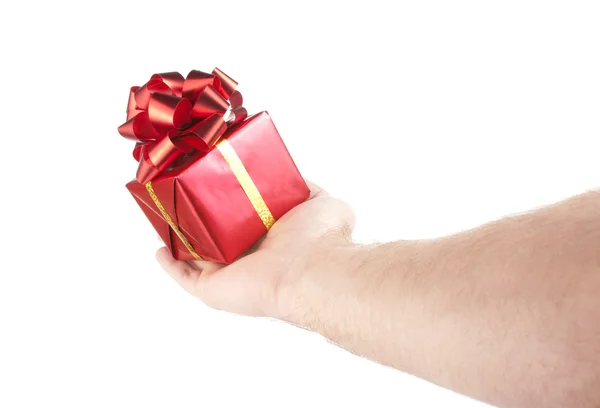Pequeño regalo rojo en palma de la mano —  Fotos de Stock