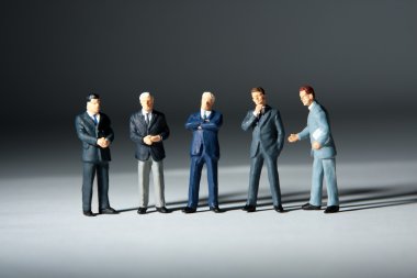 Miniature figurines of successful business team clipart