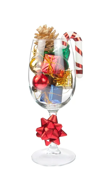 Wine glass full of Christmas decorations — Stock Photo, Image