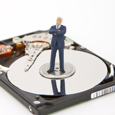 IT security. Businessman on computer hard drive clipart