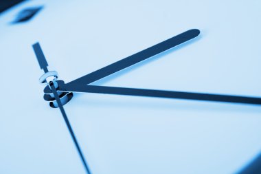 Close-up of clock hands. Toned in blue clipart