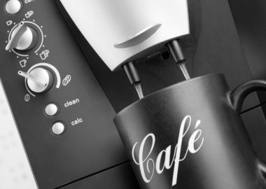 Espresso pouring into black cup from coffee machine clipart