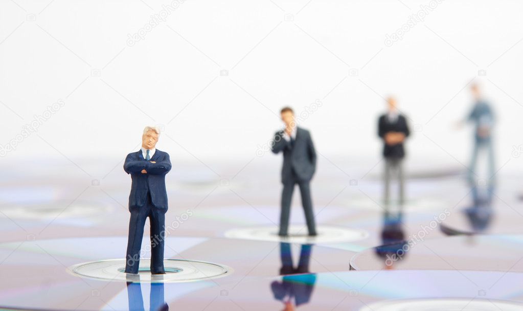 Business standing on computer CDs