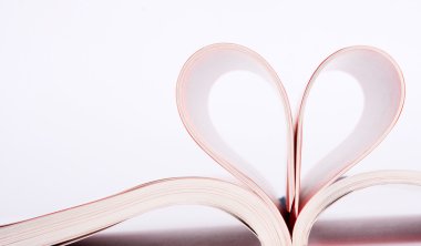 Close-up of book pages folded into a heart shape clipart