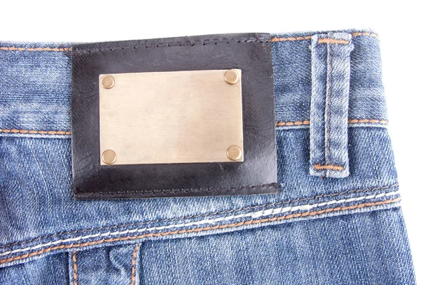 Närbild Blå Jeans Med Brons Etikett Isolerad Vit — Stockfoto
