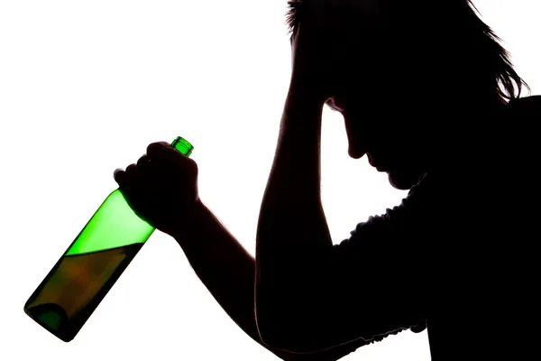 Silhouette of sad man drinking alcohol — Stock Photo, Image