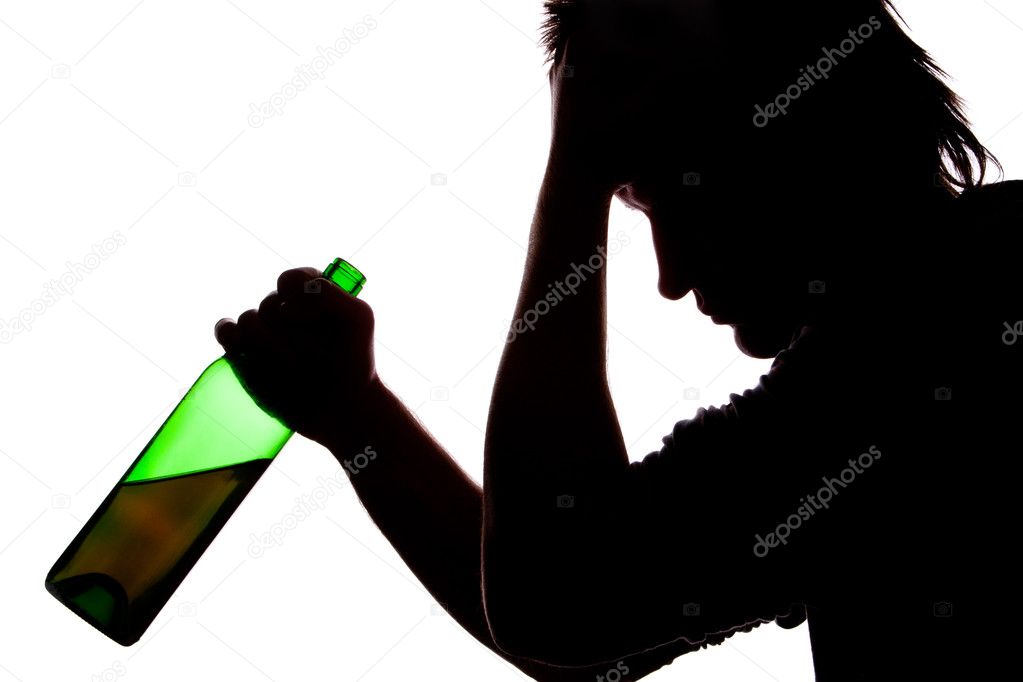 Silhouette of sad man drinking alcohol