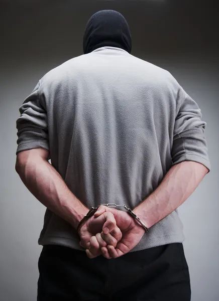 Big criminal locked in handcuffs — Stock Photo, Image
