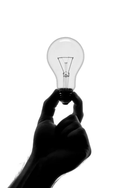 Silhuett av hand som håller glödlampan — Stockfoto