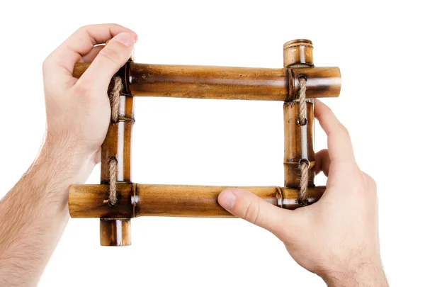 Man hands holding bamboo frame — Stock Photo, Image