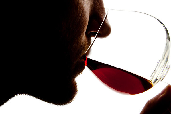 Silhouette of man tasting alcohol